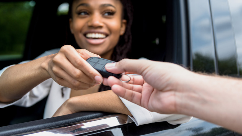 woman receiving car key fob